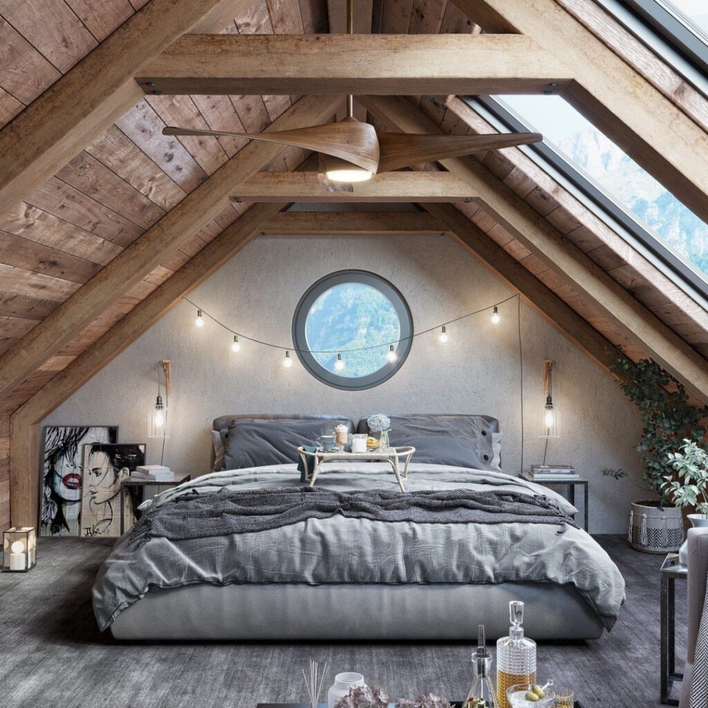 Bedroom with cathedral ceiling, exposed wooden beams, skylights, and a grey bed.