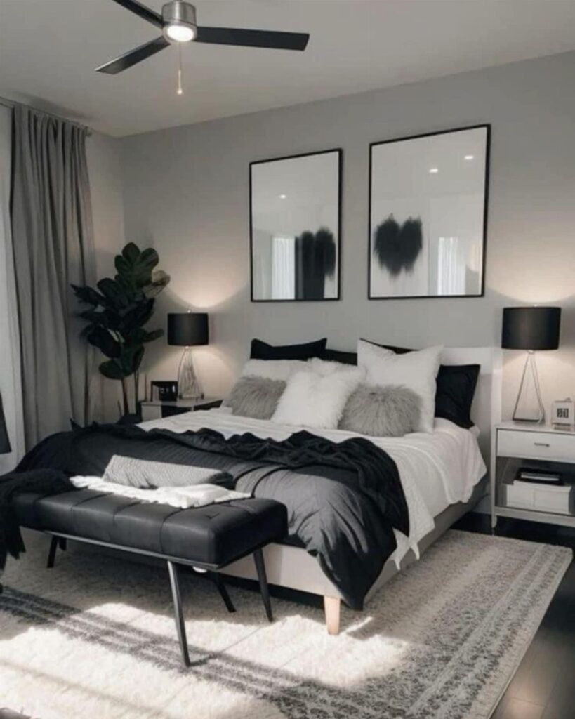 Modern bedroom with grey walls, black and white bedding, and abstract wall art.
