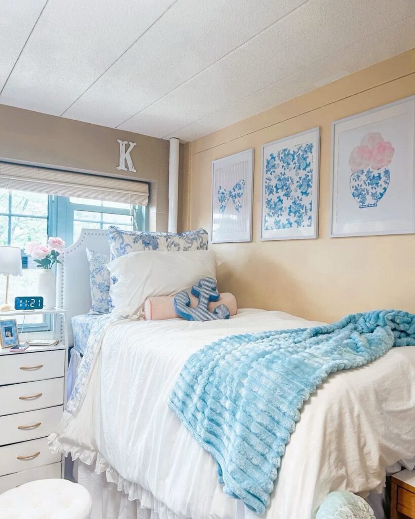 Bed with white linens and light blue throw blanket in a blue-themed room