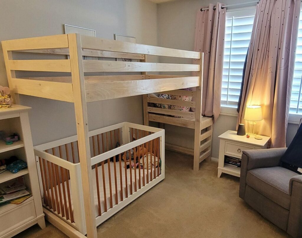 Wooden loft bed with a matching crib placed underneath in a neutral bedroom