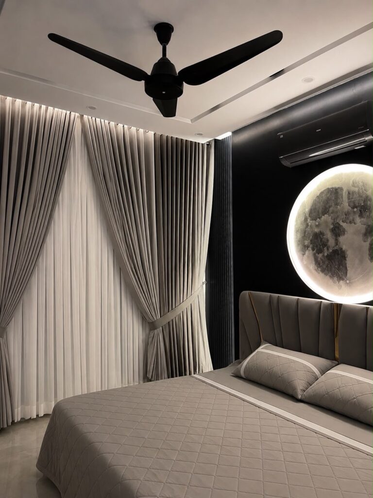 Grey and white layered curtains in a modern bedroom with a moon light.