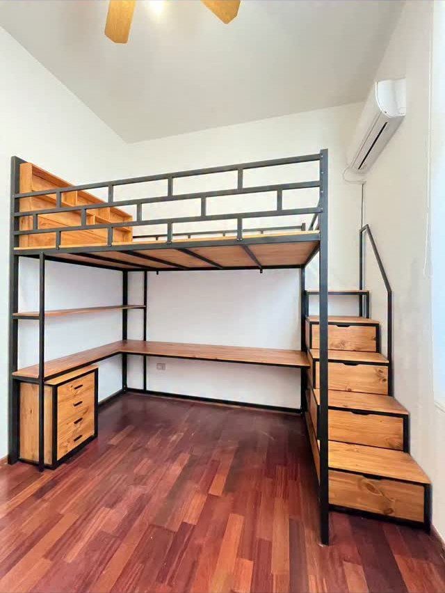 Loft bed frame with integrated desk and storage drawers under the bed stairs.
